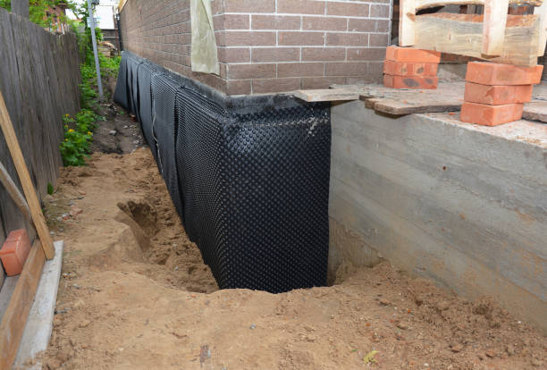 Happy homeowners after waterproofing job in New Holstein